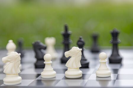 chess board game, strategy and competition in business concept with green background