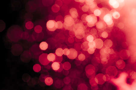 Red light glowing defocused holiday blurr bokeh in black backgeound