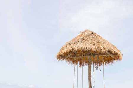 An umbrella made of straw on the beachの写真素材