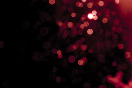 Abstract decorat  bokeh holiday christmas glowing lights on black backgroundの写真素材