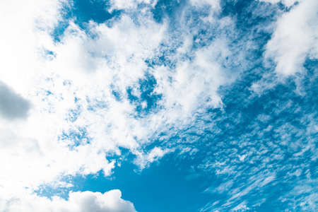 Blue sky with fluffy white clouds for backgroundの写真素材