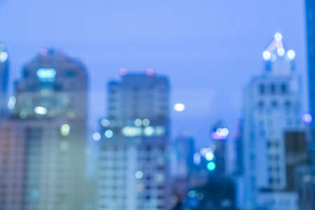 Blur image of city scape building in the night with light bokeh backgroundの写真素材
