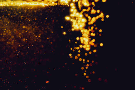 Glittering stars of blur gold  bokeh use for celebrate with black background