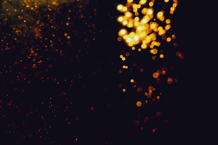 Glittering stars of blur gold  bokeh use for celebrate with black background