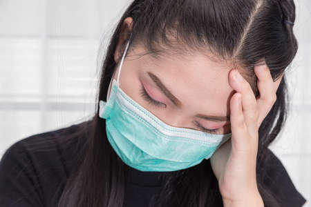 Asian woman wears a medical mask to protect against Covid's disease.の写真素材