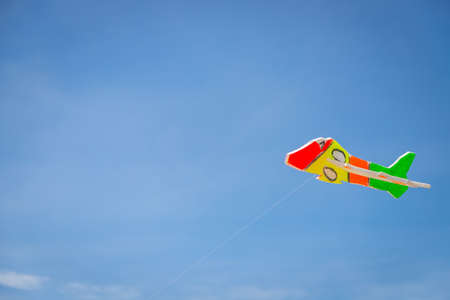 The toy plane is made of colorful foam to catch the wind on the beach.の写真素材