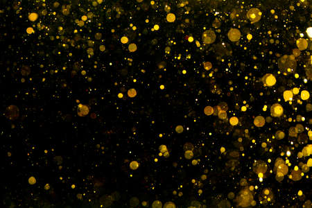 Gold and yellow bokeh of light textured glitter use for Christmas day background