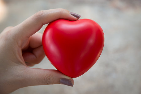 Woman hold red heart use for backgroundの写真素材