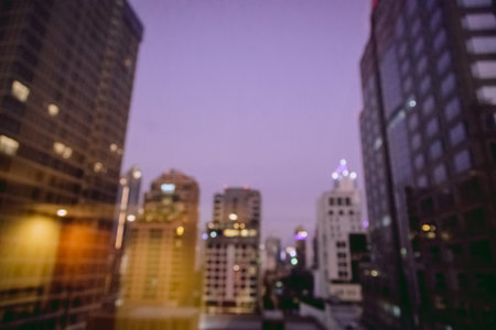 Blur image of city scape building in the night with light bokeh background