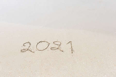 Happy New Year 2021 is coming concept sandy tropical ocean beach lettering nature backgroundの写真素材