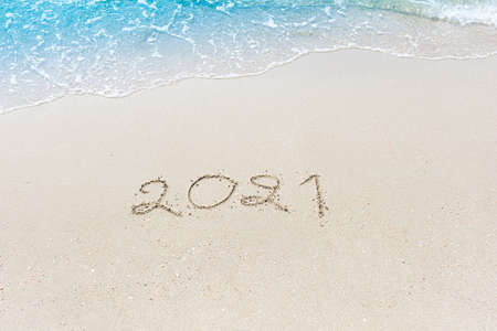 Happy New Year 2021 is coming concept sandy tropical ocean beach lettering nature backgroundの写真素材
