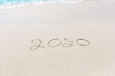 Happy New Year 2020 is coming concept sandy tropical ocean beach lettering nature backgroundの写真素材