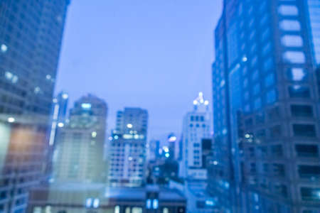 Blur image of city scape building in the night with light bokeh backgroundの写真素材