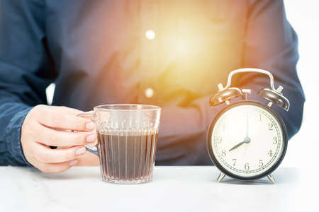 Business people planning work with coffee cups and clocks on the table backgroundの写真素材