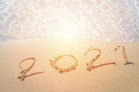 Happy New Year 2021 is coming concept sandy tropical ocean beach lettering nature background