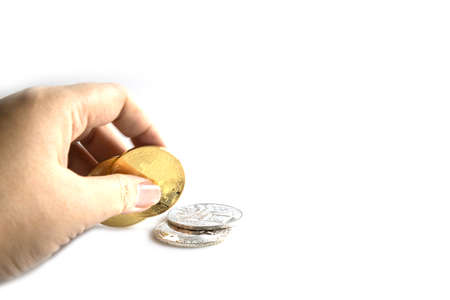 Business hand to pick up bitcoins on white background