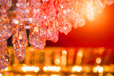 Beautiful crystal chandeliers warm light reflecting through brushed czech glass crystals hanging on...