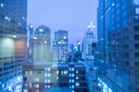Blur image of city scape building in the night with light bokeh backgroundの写真素材