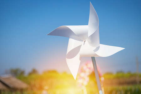White windmill in the middle of the meadow was blurred with the wind and the sky was in the backgroundの写真素材