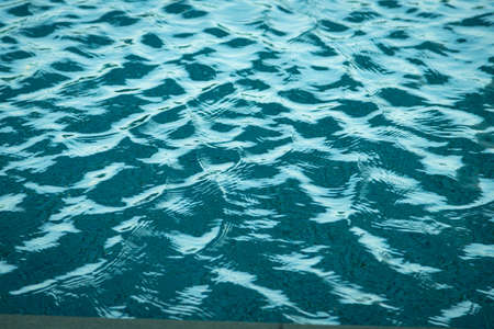 Light Blue swimming pool rippled water texture reflectionの写真素材