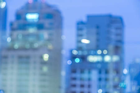 Blur image of city scape building in the night with light bokeh backgroundの写真素材