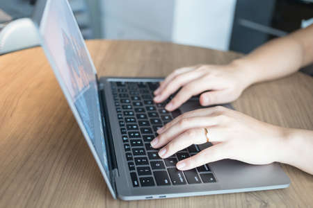 Working from home on laptop while typing chat to customer communicates on internet in home office, Concept of remote work e-learning business from homeの写真素材