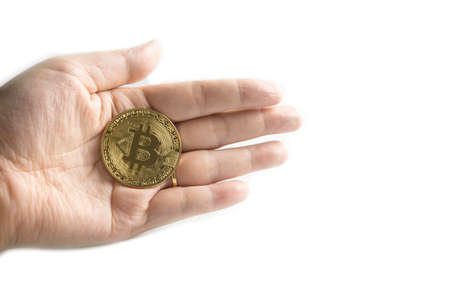 Business hand to pick up bitcoins on white backgroundの写真素材