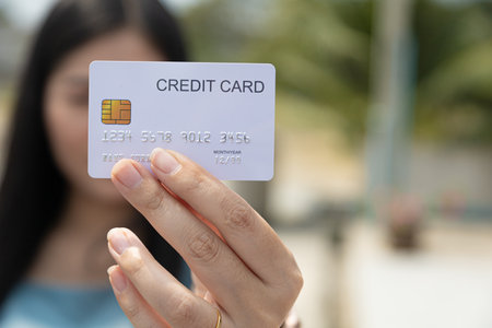 Closeup hand takes of credit card for financial transactions and blurred background womenの写真素材