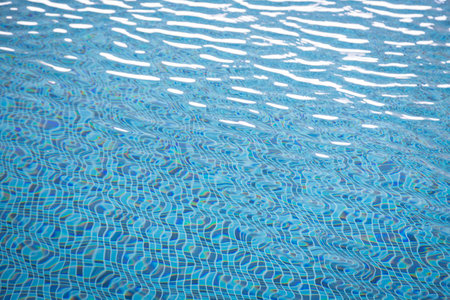 Light Blue swimming pool rippled water texture reflectionの写真素材