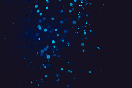Vintage blue bokeh created by neon lights with black backgroundの写真素材