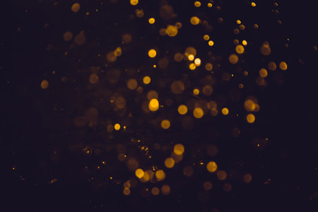 Gold bokeh blurred luxury with black backgroundの写真素材