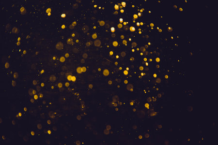 Vintage gold bokeh created by neon lights with black backgroundの写真素材