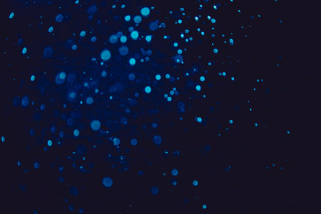 Vintage blue bokeh created by neon lights with black backgroundの写真素材