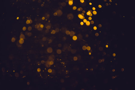 Gold bokeh blurred luxury with black backgroundの写真素材