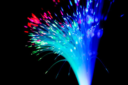 Close up of blurred light fiber optics for communication technology network on black backgroundの写真素材