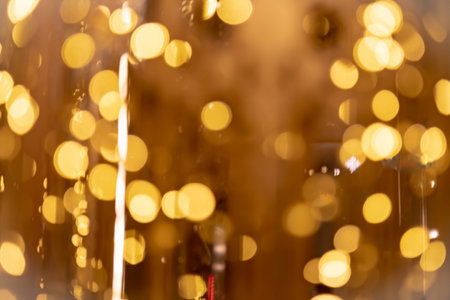 Abstract gold bokeh from light with black backgroundの写真素材