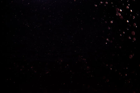 Abstract bokeh of light texture on black backgroundの写真素材
