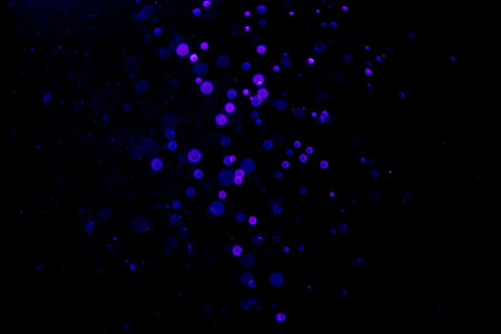 Abstract blue bokeh of water with black backgroundの写真素材