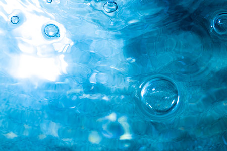 Water bubbWater bubbles abstract bokeh light in the pool backgroundles abstract bokeh light in the pool backgroundの写真素材