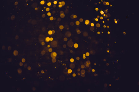 Gold bokeh blurred luxury with black backgroundの写真素材