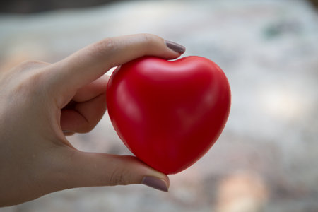 Woman hold red heart use for backgroundの写真素材