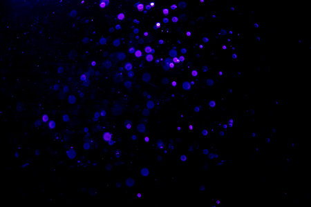 Abstract blue bokeh of water with black backgroundの写真素材