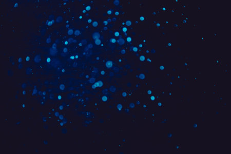 Vintage blue bokeh created by neon lights with black backgroundの写真素材