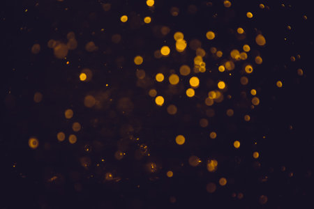Gold bokeh blurred luxury with black backgroundの写真素材