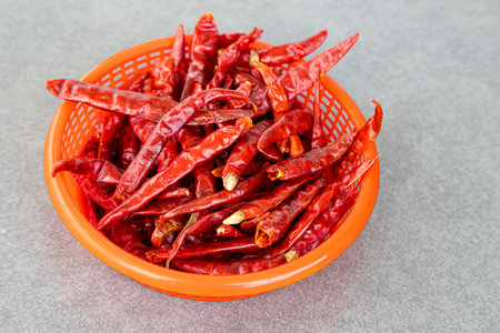 Dry chillies in the red bowl isolate gray backgroundの写真素材