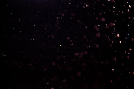Abstract bokeh of light texture on black backgroundの写真素材