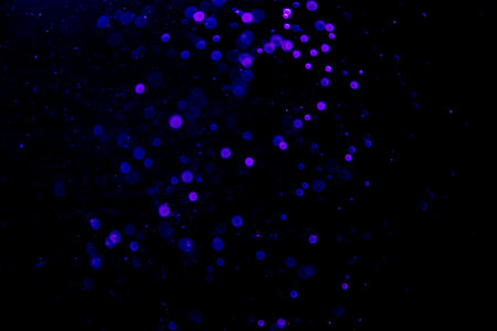 Abstract blue bokeh of water with black backgroundの写真素材