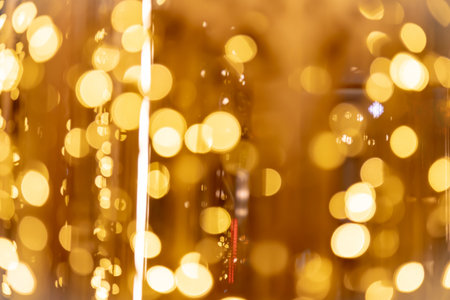 Abstract gold bokeh from light with black backgroundの写真素材