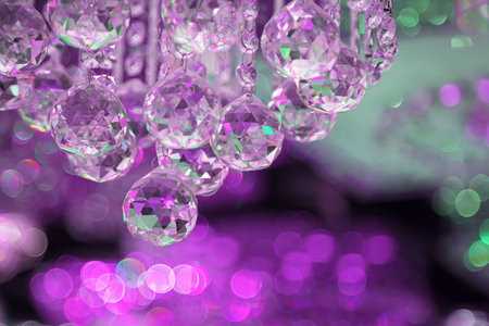 Beautiful crystal chandeliers warm light Light reflecting through brushed czech glass crystals hanging on vintage chandelier with bokeh backgroundの写真素材
