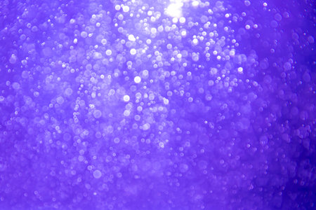 Abstract purple bokeh glitter lights defocused backgroundの写真素材